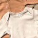 beige and orange organic onesies