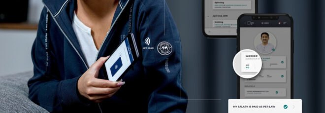 woman smiling and using phone app to scan a tag on her sweatshirt