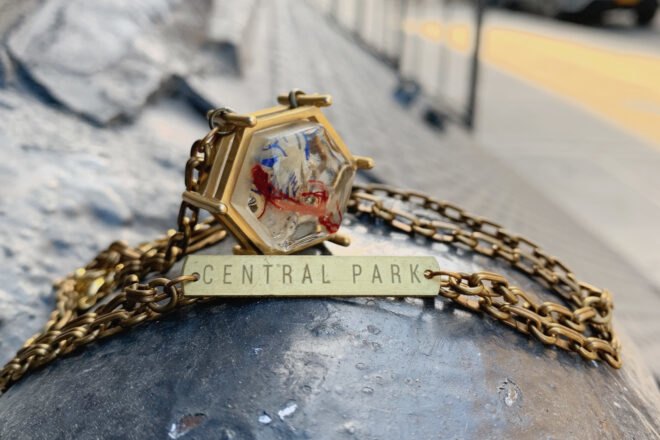 gold pendant made out of trash with gold tag that reads, "Central Park"