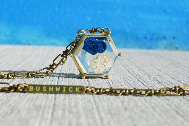 blue balloon and chunk of Styrofoam inside a gold pendant