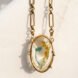 blue and yellow trash enclosed in a gold necklace