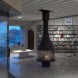 black fireplace in room with floor-to-ceiling bookshelves