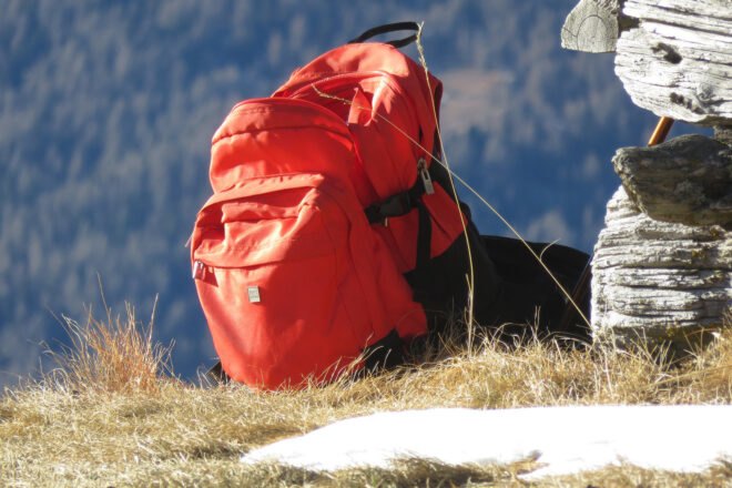 red backpack on a mountainside