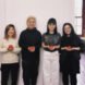 four people holding tomatoes