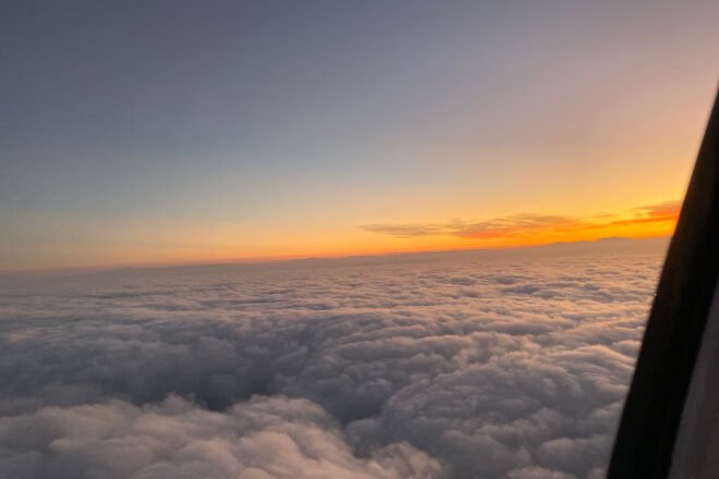 view of clouds and sunset from a plane window