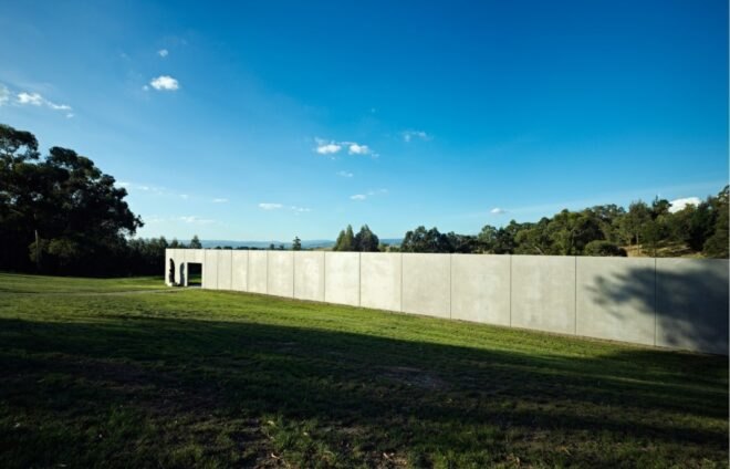 a long gray cement structure with an open walk-through area