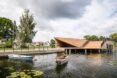 boat sailing toward wood building