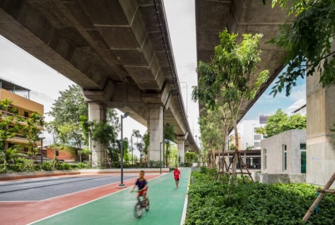 rendering of trees and a bike path under a highway ramp