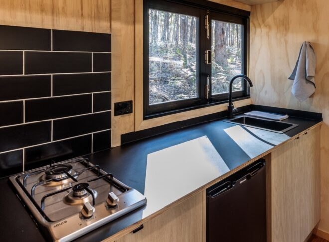 kitchen with black subway tile backsplash and black countertops