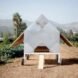 small metallic chicken coop with gabled roof and wheels