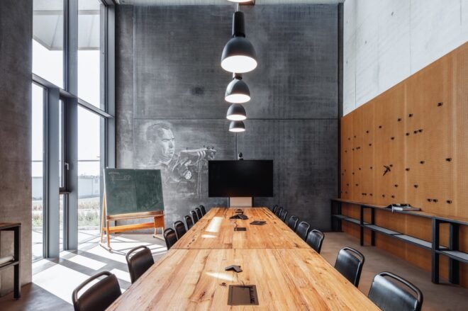 meeting room with wall mural, small chalkboard and long wood table