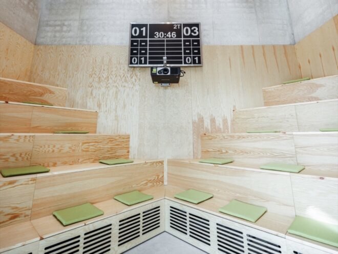 wood room with stacked benches and a scoreboard