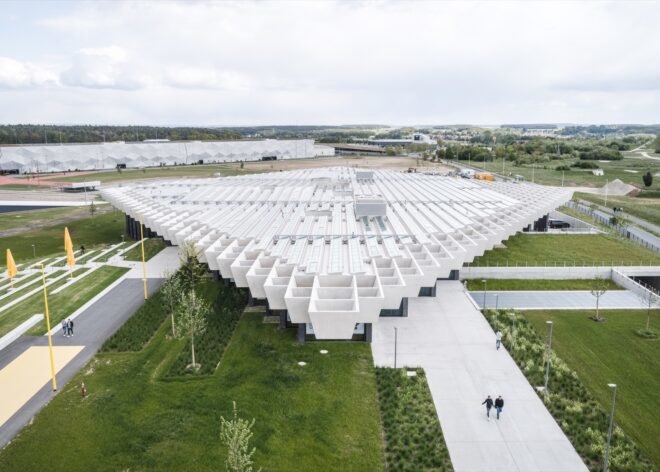 aerial view of glass building with white rhomboid roof