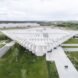 aerial view of glass building with white rhomboid roof