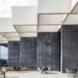 black and white dining sets on outdoor patio beside gray office building