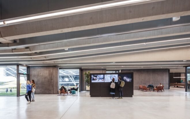 people looking at screens inside an office building