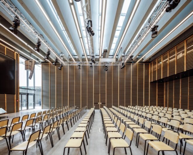 auditorium with wood seats and a large TV screen