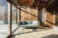 wood-lined living space with small, pale-green sofa