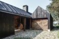 A-frame cabin with structure filled with firewood