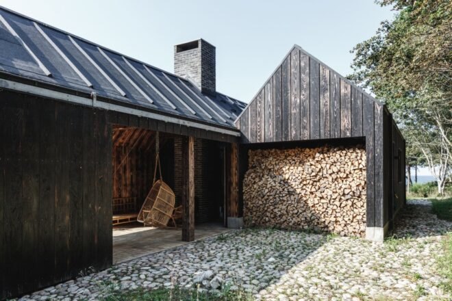 A-frame cabin with structure filled with firewood