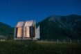 small, clear cabin lit from within at night