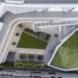 a birds-eye view of the housing project, showing several green spaces and white/gray walkways