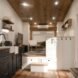 tiny home with white walls and a kitchen with black cabinetry