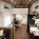 tiny home with white walls, dark wood floors and dark wood ceilings