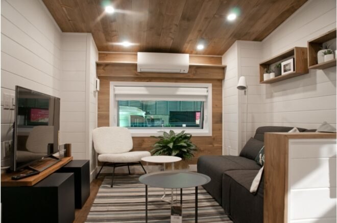 tiny house interior with dark sofa and white chair