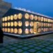 gabled building with bubble-like windows all lit up from within at night