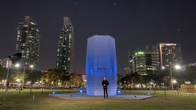 designer standing in front of smog-eating tower