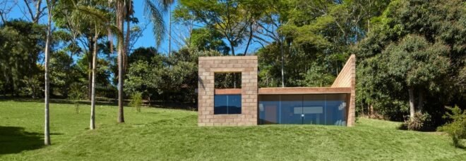 small brick home with one wall of glass
