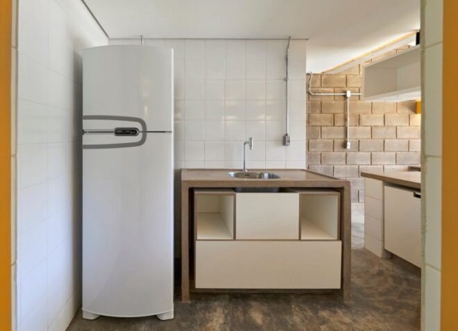 kitchen with wood counters and a tall, narrow white fridge