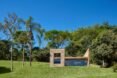 small brick home with one wall of glass