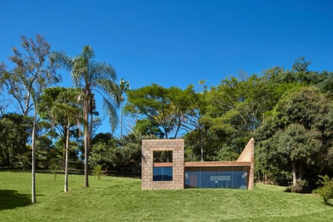small brick home with one wall of glass