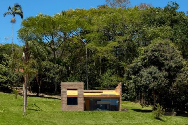 small brick home with one wall of glass
