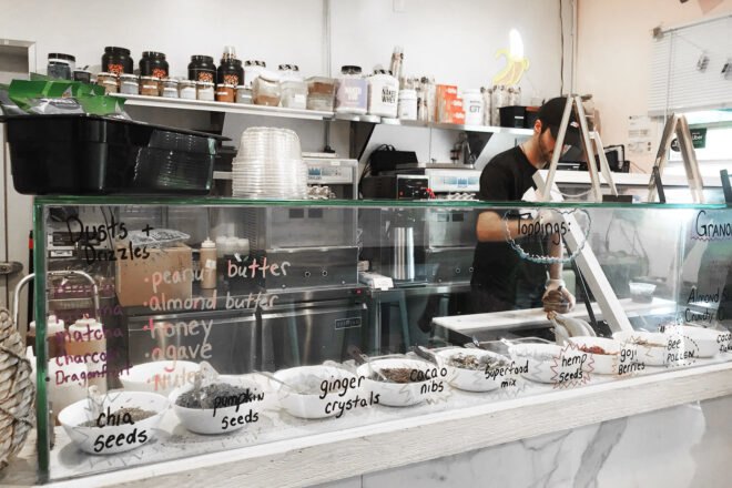 The food counter inside Sweet Soul with a person working behind the counter