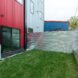 small green yard with corrugated metal fencing