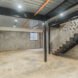 large gray room with black metal and wood staircase