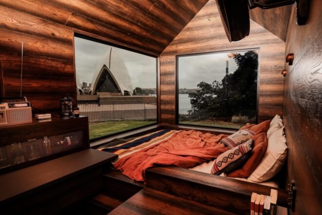 wood-clad interior of tiny cabin with large windows