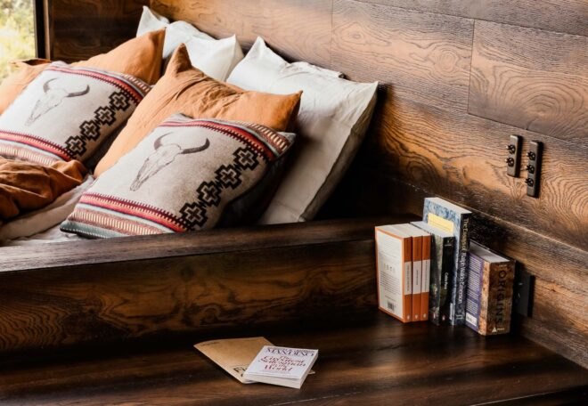 A table full of books next to a pull-out sofa