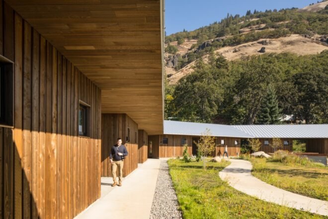 walkways connecting wood cabins near a mountain