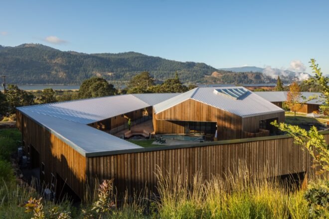 ring of wood cabins surrounding a wood sauna building
