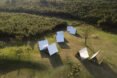 aerial view of A-frame cabins with reflective exterior