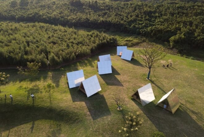 aerial view of A-frame cabins with reflective exterior