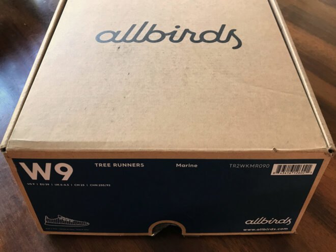 cardboard shoebox that reads, "Allbirds"