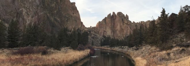 river flowing near large rock formations