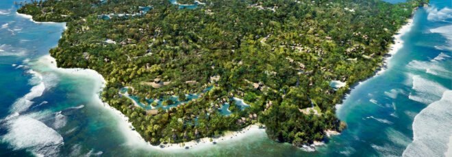 aerial rendering of resort lodgings on lush island