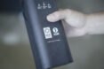 person holding container with logos for Climate Neutral Certification and 1% for the Planet
