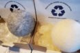 wool dryer balls on top of cardboard boxes filled with laundry pods